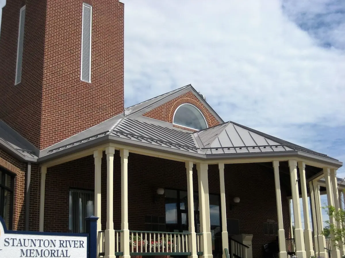 Skilled roofing craftsmen working on a residential roof in Big Flats